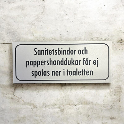 Trivselskylt Sanitetsbindor och pappershanddukar får ej
